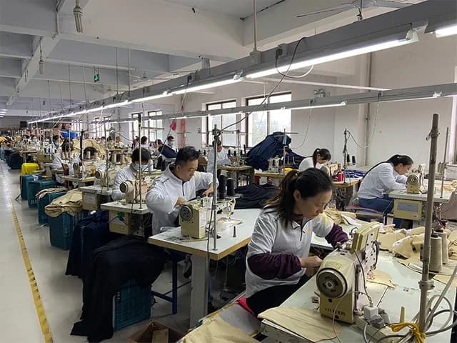 Garment assembly line with sewing operators and bundles of fabric panels