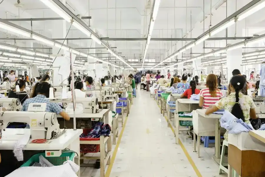 Garment sewing floor with parallel workstations, operators and fabric bundles